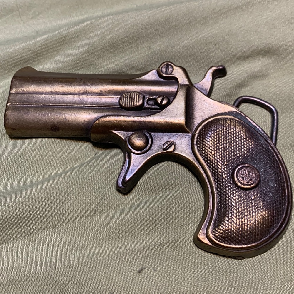 Brass gun shaped metal belt buckle